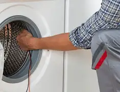 Dryer repair technician diagnosing and servicing a clothes dryer in Bloomington, IN