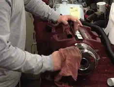 Vacuum repair technician cleaning and servicing a vacuum motor in Bloomington, IN