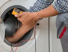 Washing machine repair technician testing a front-load washer with diagnostic tools in Bloomington, IN